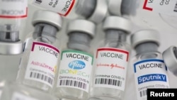 Vials labeled AstraZeneca, Pfizer-BioNtech, Johnson&Johnson, Sputnik V coronavirus disease (COVID-19) vaccine. (REUTERS/Dado Ruvic/Illustration)