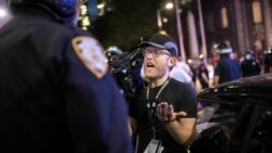 Associated Press videojournalist Robert Bumsted reminds a police officer that the press are considered “essential workers" and are allowed to be on the streets despite a curfew, Tuesday, June 2, 2020, in New York. New York City police officers…