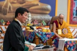 FILE - Tibetan spiritual leader the Dalai Lama, right, listens to Lobsang Sangay, president of the Tibetan government-in-exile, during an event at the Kirti Monastery in Dharmsala, India, Dec. 7, 2019.