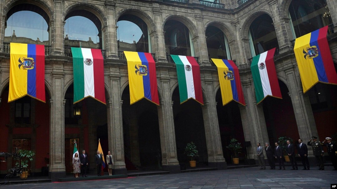 FILE - Mexican and Ecuadoran flags hang at the National Palace in Mexico City, Nov. 24, 2022. Mexican President Andres Manuel Lopez Obrador broke diplomatic ties with Ecuador on April 5, 2024, after Ecuadoran police broke into the Mexican Embassy in Quito.