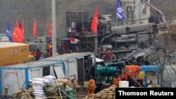 Rescuers work at the Hushan gold mine where workers were trapped underground after the Jan. 10 explosion, in Qixia, Shandong province, China, Jan. 22, 2021.