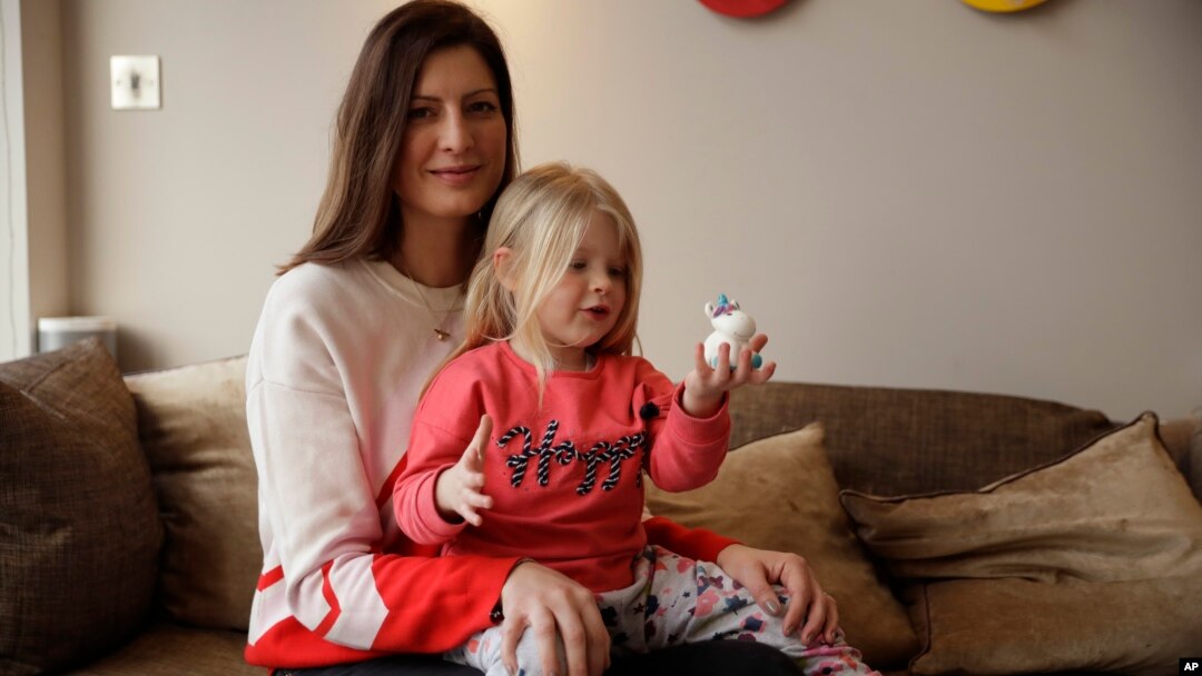 Victoria Mickleburgh and her daughter Grace pose for photographs at their home in Cobham on the outskirts of southwest London, Jan. 23, 2019. 