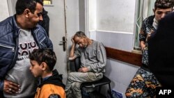 FILE - A man, who was detained with other Palestinians by the Israeli military and released through the Kerem Shalom crossing, reacts as he awaits treatment for his injuries at al-Najjar hospital in Rafah in the southern Gaza Strip on December 24, 2023,