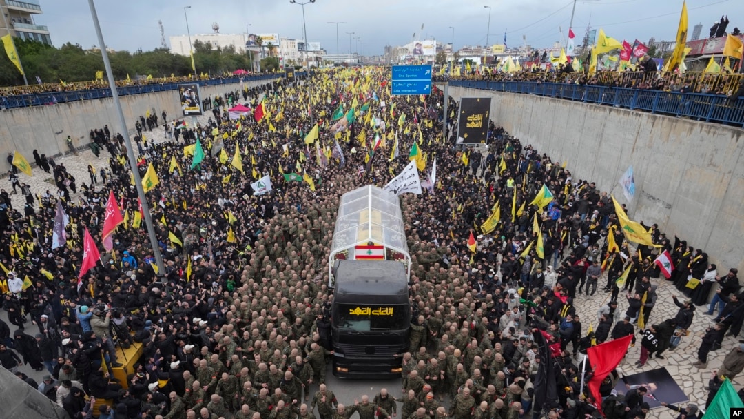 A trailer carrying the coffins containing the bodies of Hezbollah's former leader Hassan Nasrallah and his cousin and successor Hashem Safieddine enters the Sports City Stadium during a funeral procession in Beirut, Feb. 23, 2025.