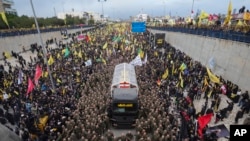 A trailer carrying the coffins containing the bodies of Hezbollah's former leader Hassan Nasrallah and his cousin and successor Hashem Safieddine enters the Sports City Stadium during a funeral procession in Beirut, Feb. 23, 2025.