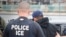 FILE - U.S. Immigration and Customs Enforcement (ICE) agents arrest foreign nationals, Feb. 7, 2017, in Los Angeles. In New York on Tuesday a lawyer threatened to call ICE because he heard cafe workers speaking Spanish.