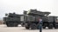 FILE - Russian soldier in ceremonial uniform stand by Pantsir-S SA-22 surface-to-air missile systems during the Victory Day military parade, at the Russian military Hmeimim base in south-east of the Syrian city of Latakia. 