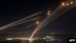 TOPSHOT - Rockets fired from southern Lebanon are intercepted by Israel's Iron Dome air defence system over the Upper Galilee region in northern Israel, on August 4, 2024, amid ongoing cross-border clashes between Israeli troops and Lebanon's Hezbollah fi