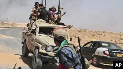 Rebelles libyens revenant d'un combat à 100 kms de Tripoli