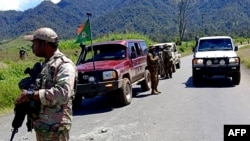This handout picture released by the Royal Papua New Guinea Constabulary on Feb. 19, 2024, shows officials patrolling near the town of Wabag, 600 kilometres northwest of the capital Port Moresby.