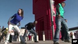 A dance troope performs near an outdoor FIFA-sponsored fan park in Johannesburg, South Africa