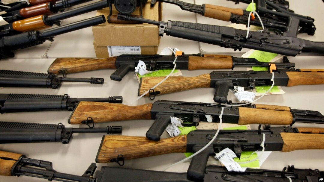 FILE - A cache of seized weapons is displayed in Phoenix, Jan 25, 2011.