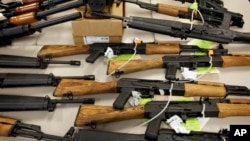 FILE - A cache of seized weapons is displayed in Phoenix, Jan 25, 2011.