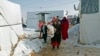 A Syrian refugee family carries 18-day-old triplets, whose mother died during childbirth in a nearby hospital, in a refugee camp near Zahle town in the Bekaa Valley, Lebanon, Jan. 18, 2015.