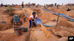 FILE—A woman works at an Illegal tin mining site in Jos, Nigeria, April 3, 2024.