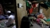 FILE - Rohingya refugee Shahid Hussain, 10, offers prayers after Iftar (breaking fast) time as his sister Sania, 2, sleeps in the next room at their house in a camp.