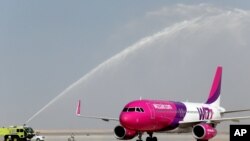 FILE - A Wizz Air jet lands at Al Maktoum International Airport in Dubai, United Arab Emirates, Oct. 27, 2013. 