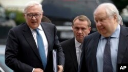 Russian Deputy Foreign Minister Sergei Ryabkov, left, and Russian Ambassador to the U.S. Sergey Kislyak, right, arrive at the State Department in Washington, July 17, 2017, for talks with Undersecretary of State Thomas Shannon. 