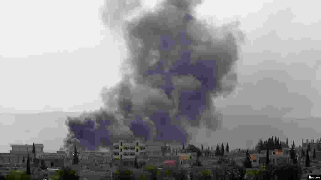 Smoke rises from the Syrian town of Kobani, seen from near the Mursitpinar border crossing on the Turkish-Syrian border in the southeastern town of Suruc, Sanliurfa province, Oct. 3, 2014.