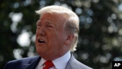 FILE - President Donald Trump talks to reporters on the South Lawn of the White House before departing for his Bedminster, N.J. golf club, July 5, 2019, in Washington. 