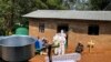 Ebola workers enter a house to decontaminate the body of a woman suspected of dying from Ebola, before the vehicle of the health ministry Ebola response team was attacked in Beni, northeastern Congo Monday, June 24, 2019.