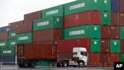 FILE - A truck leaves a container terminal in Tokyo, Japan.