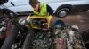 FILE - Samo Oblak sorts out computer parts at a dump yard in Kranj, Slovenia. 