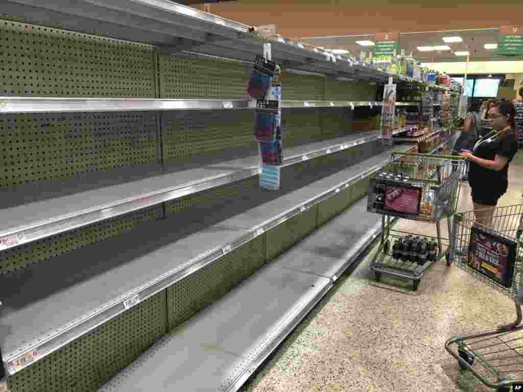 Store shelves are empty of bottled water as locals buy supplies in preparation for Hurricane Dorian, in Doral, Florida. The U.S. National Hurricane Center says Dorian could hit the Florida coast over the weekend as a major hurricane.