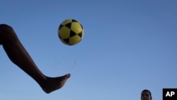 FILE: In this May 31, 2014 file photo, a player controls a ball during a game of "altinho," where the goal is to keep the ball airborne while passed amid players.