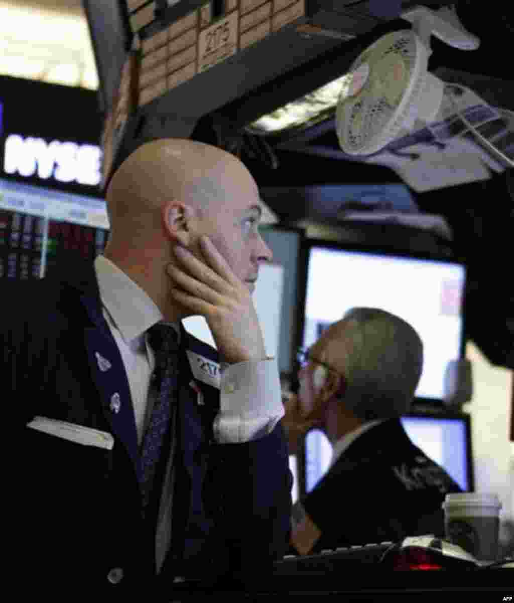 FILE - In this Oct. 3, 2011 file photo, traders work on the floor at the New York Stock Exchange. Stocks slid again Tuesday, Oct. 4, as Europe's debt crisis showed few signs of being solved any time soon and officials said Greece will have to wait until N