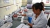 FILE - A health worker tests a blood sample to check for dengue at the Sukraraj Tropical and Infectious Disease Hospital in Kathmandu, Nepal, on Oct. 22, 2024. Climate change nurtures fever-carrying mosquitoes in new places — one health impact of rising temperatures, experts say.