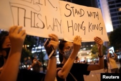 Protesters attend a "Stand With Hong Kong, Power to the People Rally" at the Chater Garden, in Hong Kong, Aug. 16, 2019.