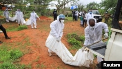 Forensic experts and homicide detectives carry the bodies of suspected members of a Christian cult named Good News International Church after their remains were exhumed from their graves in Shakahola forest of Kilifi county, Kenya, April 22, 2023.