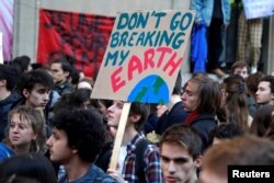 Youths demonstrate for climate change during the "Fridays for Future" school strike, in front of the Ecology Ministry in Paris, France, Feb. 15, 2019.