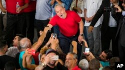 Former President Luiz Inacio Lula da Silva greets supporters during a visit to the metallurgic syndicate headquarters in Sao Bernardo do Campo, Brazil, Jan. 24, 2018. 