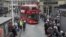 People take photos of the new routemaster double decker bus as it arrives at Victoria bus station in London, Feb. 27, 2012.