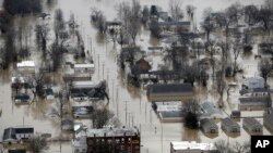 Homes surrounded by floodwater, Wednesday, Dec. 30, 2015, in Pacific, Mo.