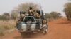 FILE - Soldiers from Burkina Faso patrol on the road of Gorgadji in the Sahel area, Burkina Faso, March 3, 2019.