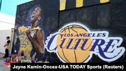 Fans gather at a mural painted in an alley on Lebanon St in Los Angeles pays tribute to Kobe Bryant who was killed in a helicopter crash Jan 26, 2020. Mandatory Credit: Jayne Kamin-Oncea-USA TODAY Sports