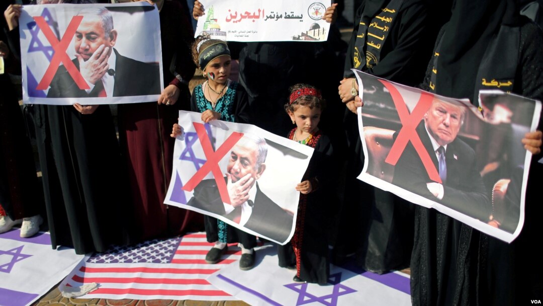 Falastinliklar Vashingtonning Yaqin Sharq rejasiga qarshi AQSh va Falastin bayroqlarini bosib, Prezident Donald Tramp va Bosh vazir Benyamin Netanyaxu suratlarini tutgan holda norozilik bildirmoqda. G'azo, 18-iyun, 2019. 