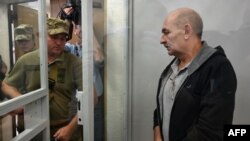  Volodymyr Tsemakh, an Ukrainian man suspected of involvement in the downing of flight MH17, is about to leave a dock of Kyiv court of appeal after the court verdict in Kyiv on Sept. 5, 2019.