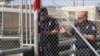 U.S. Customs and Border Protection officers reopen the border gate of the Gateway International Bridge that connects downtown Matamoros, Mexico with Brownsville, Texas, Oct. 10, 2019.