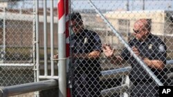 U.S. Customs and Border Protection officers reopen the border gate of the Gateway International Bridge that connects downtown Matamoros, Mexico with Brownsville, Texas, Oct. 10, 2019.