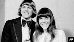 FILE - The Carpenters, Richard and Karen, pose with their Grammy during the 13th annual 1970 Grammy Awards in Los Angeles, California, March 17, 1971. 