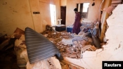 A man looks at belongings inside a damaged house during clashes between the paramilitary Rapid Support Forces and the army in Khartoum, Sudan April 17, 2023.