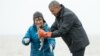President Barack Obama reacts as a fish he is holding releases milt, the sperm-containing fluid of a male fish, while visiting with Commercial and Subsistence Fisher Kim Williams on Kanakanak Beach, Sept. 2, 2015, in Dillingham, Alaska.
