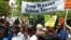 People march under a banner that reads "Stop Racist Police Terror," Baltimore, Maryland, May 2, 2015. (R. Muntu/VOA)