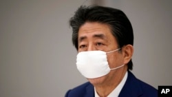 Japanese Prime Minister Shinzo Abe declares a state of emergency during a meeting of the task force against the coronavirus at the his official residence in Tokyo, Tuesday, April 7, 2020.