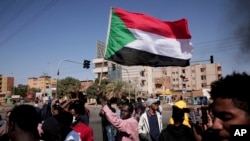 People chant slogans during a demonstration against the killing of dozens by Sudanese security forces since the Oct. 25, 2021 military takeover, in Khartoum, Sudan, Jan. 20, 2022.