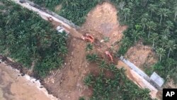 An aerial view of one of several landslides in Camarines Sur province in the Bicol region south of the main island of Luzon, is seen as President Rodrigo Duterte conducts an inspection, Jan. 4, 2019, in the Philippines.